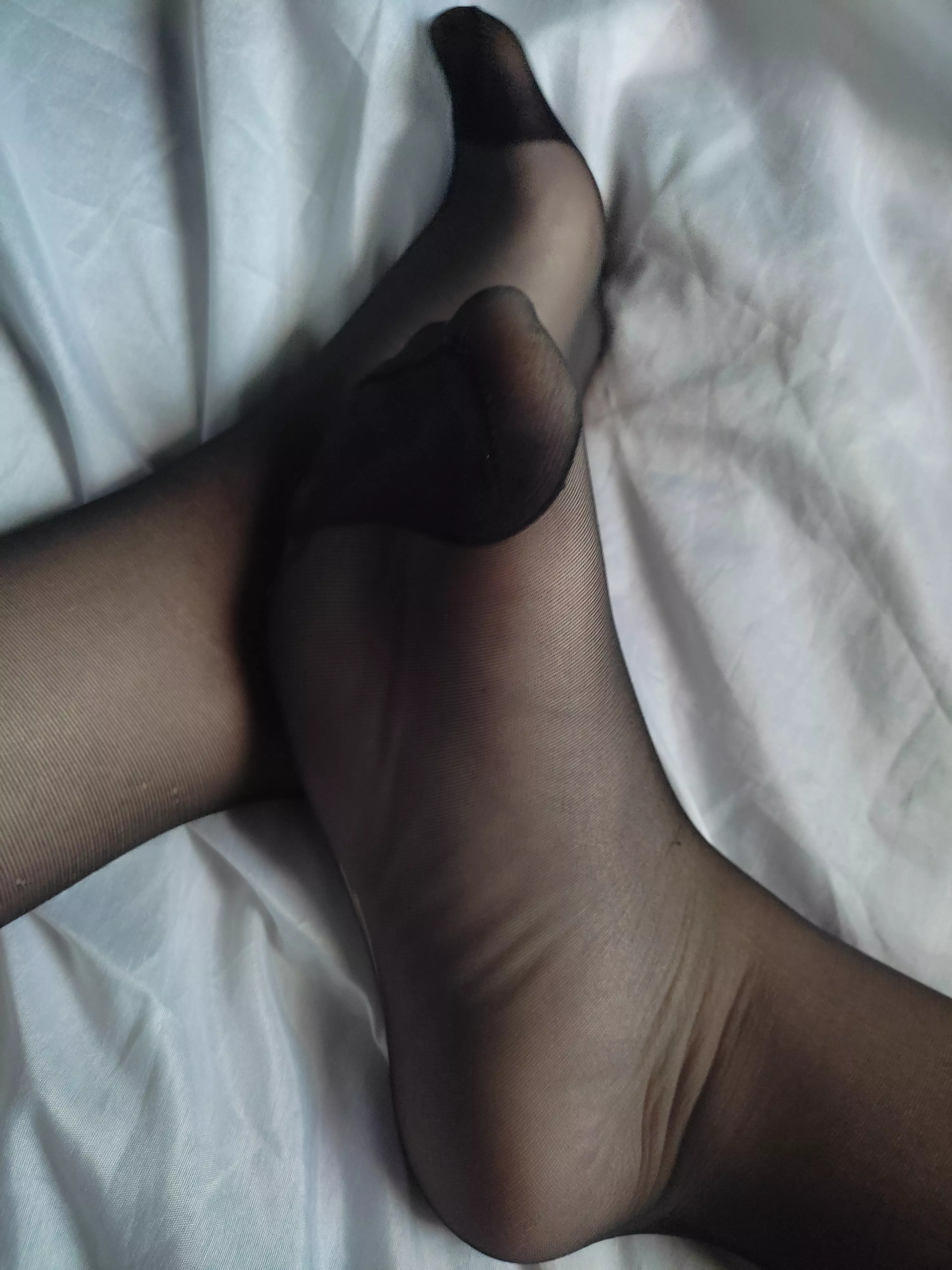Feet in black pantyhose
