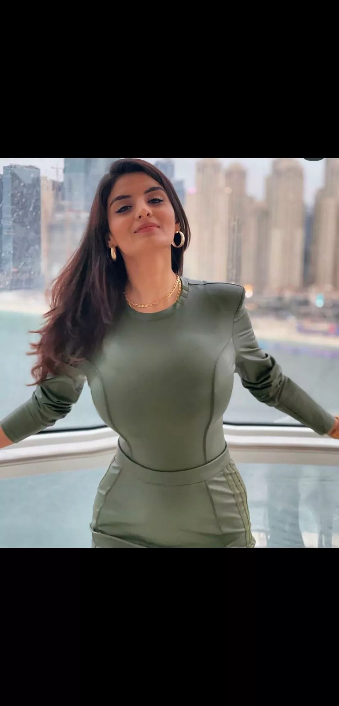 She's so hot that the railing behind her got bent on its own