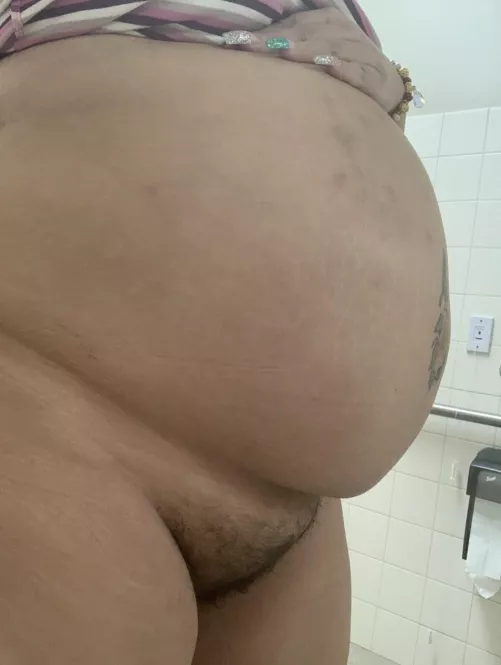In the work bathroom showing my big belly and bush
