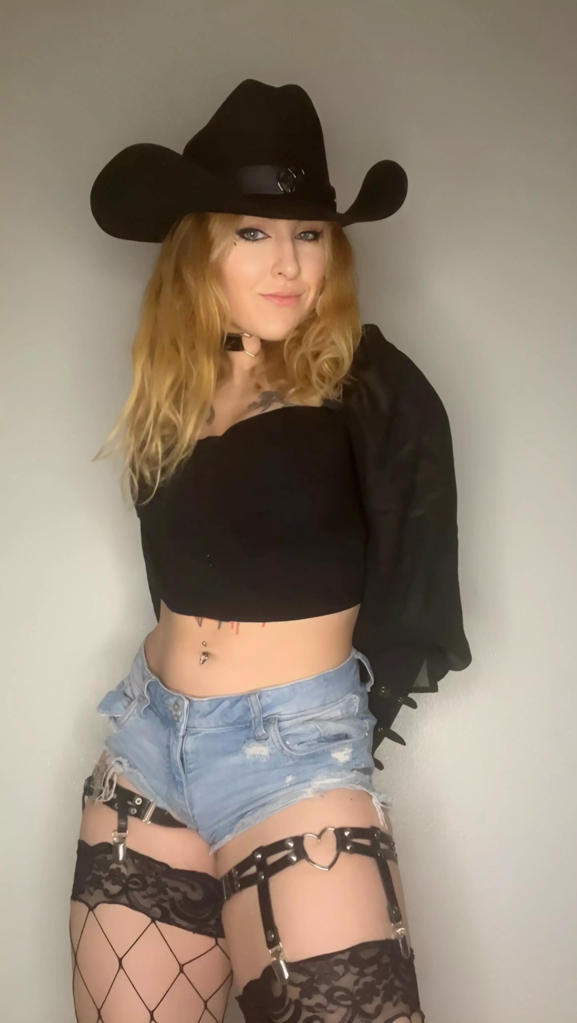 This cowboy goth girl is patiently waiting for her daddy or prince