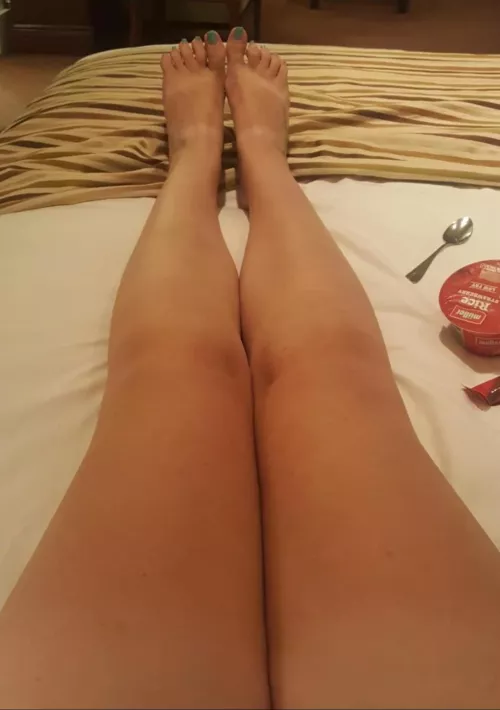 Tanned legs on the bed, red toenails...yummy