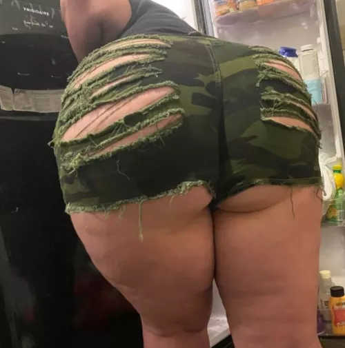 Looking in the fridge but your snack is right behind me