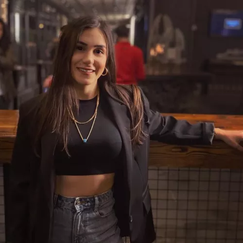 Beauty marked cutie showing bra lines through a tight black top