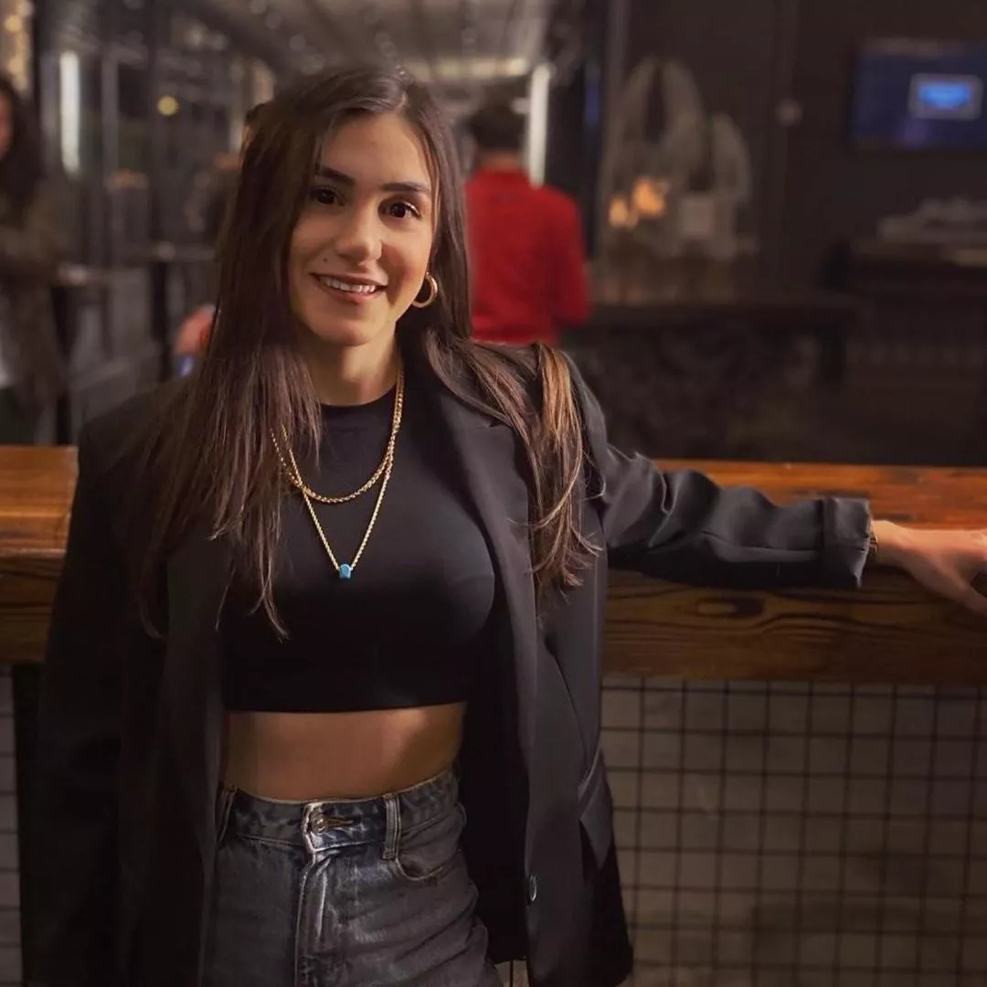 Beauty marked cutie showing bra lines through a tight black top