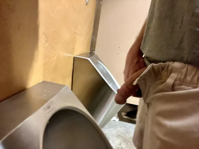 Left my growing cock out so the guy in the stall could see it when he walked out