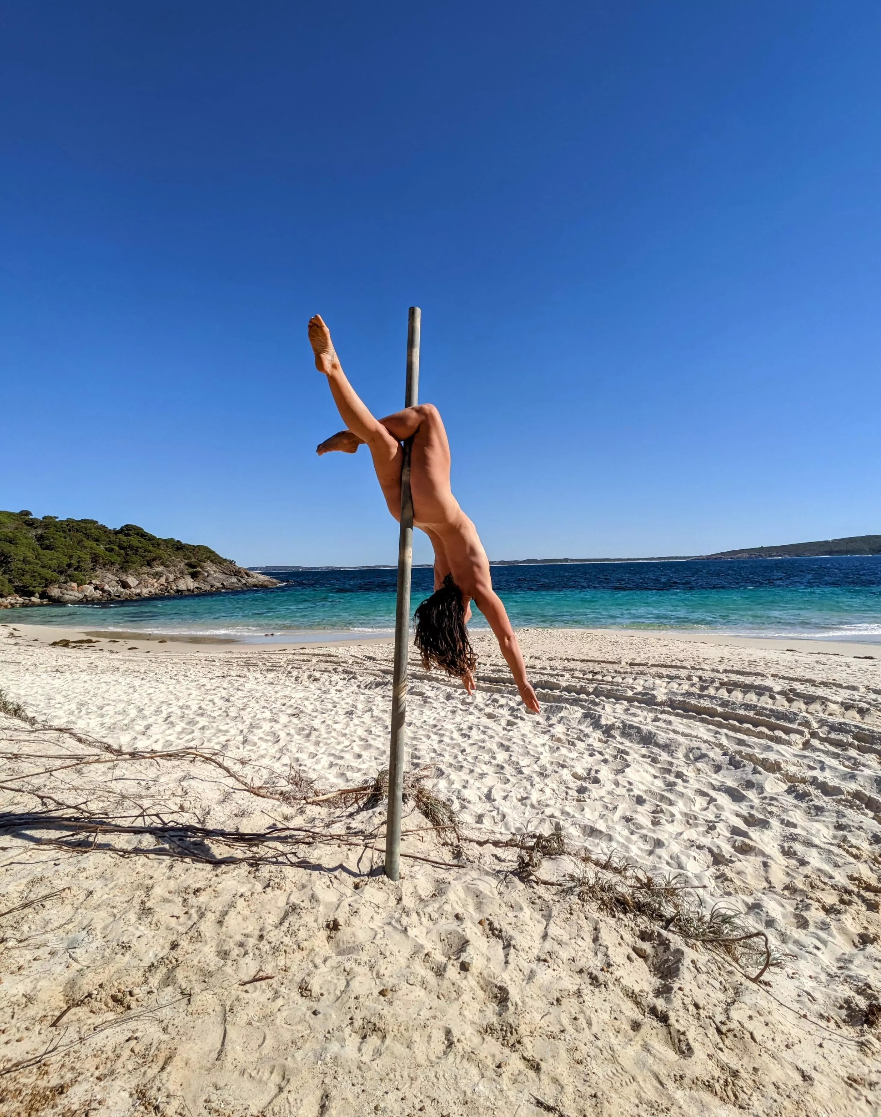 Climbing the pole at Little Boat Harbour Beach, Western Australia