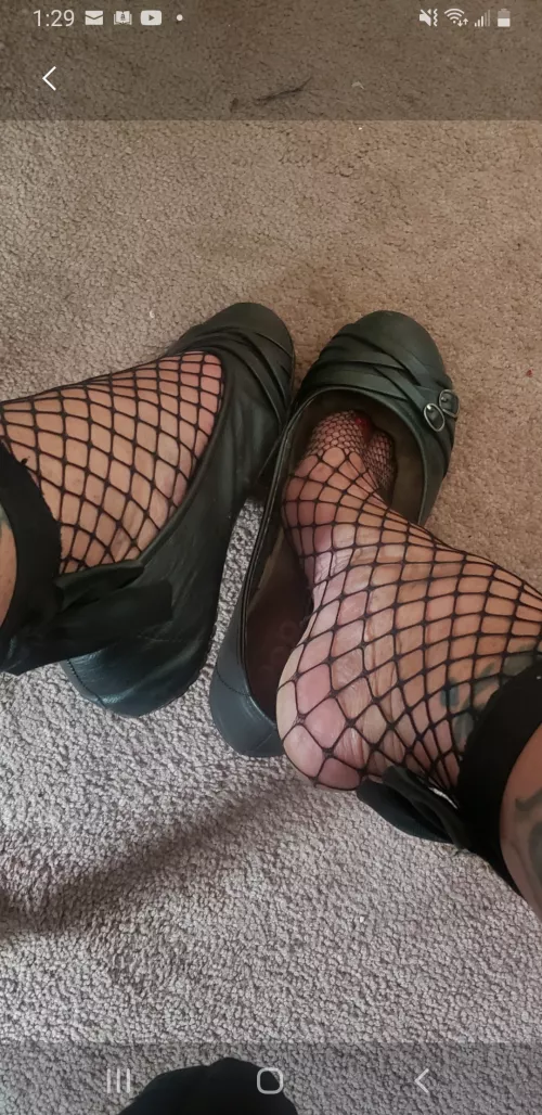 Flats with fishnet socks.