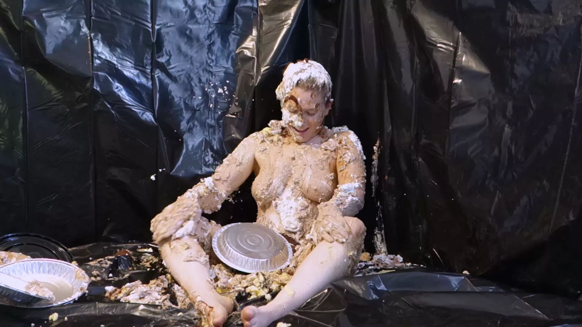 Stella looking at all the ruined dessert in her lap