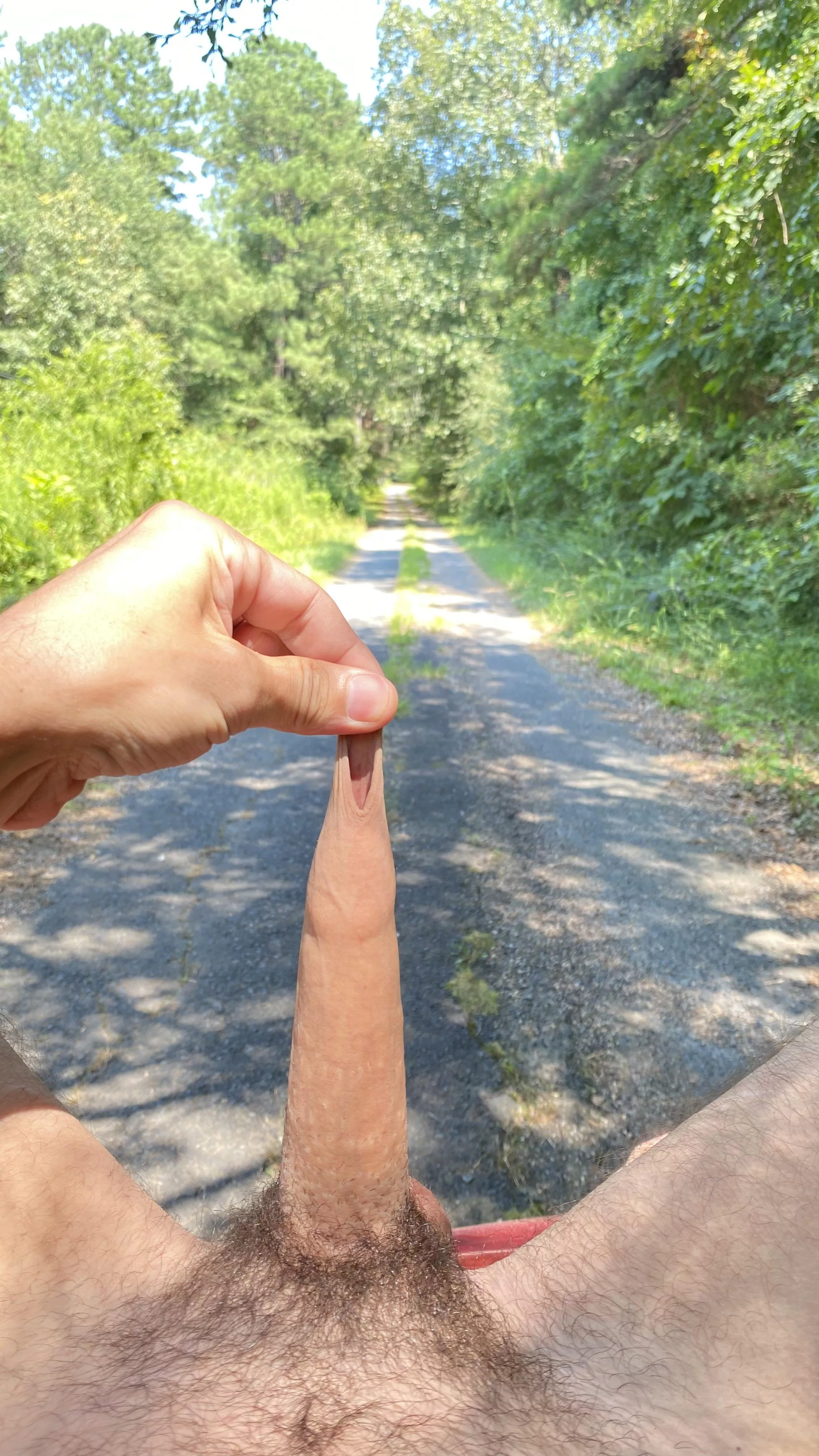 In the street playing with my foreskin.