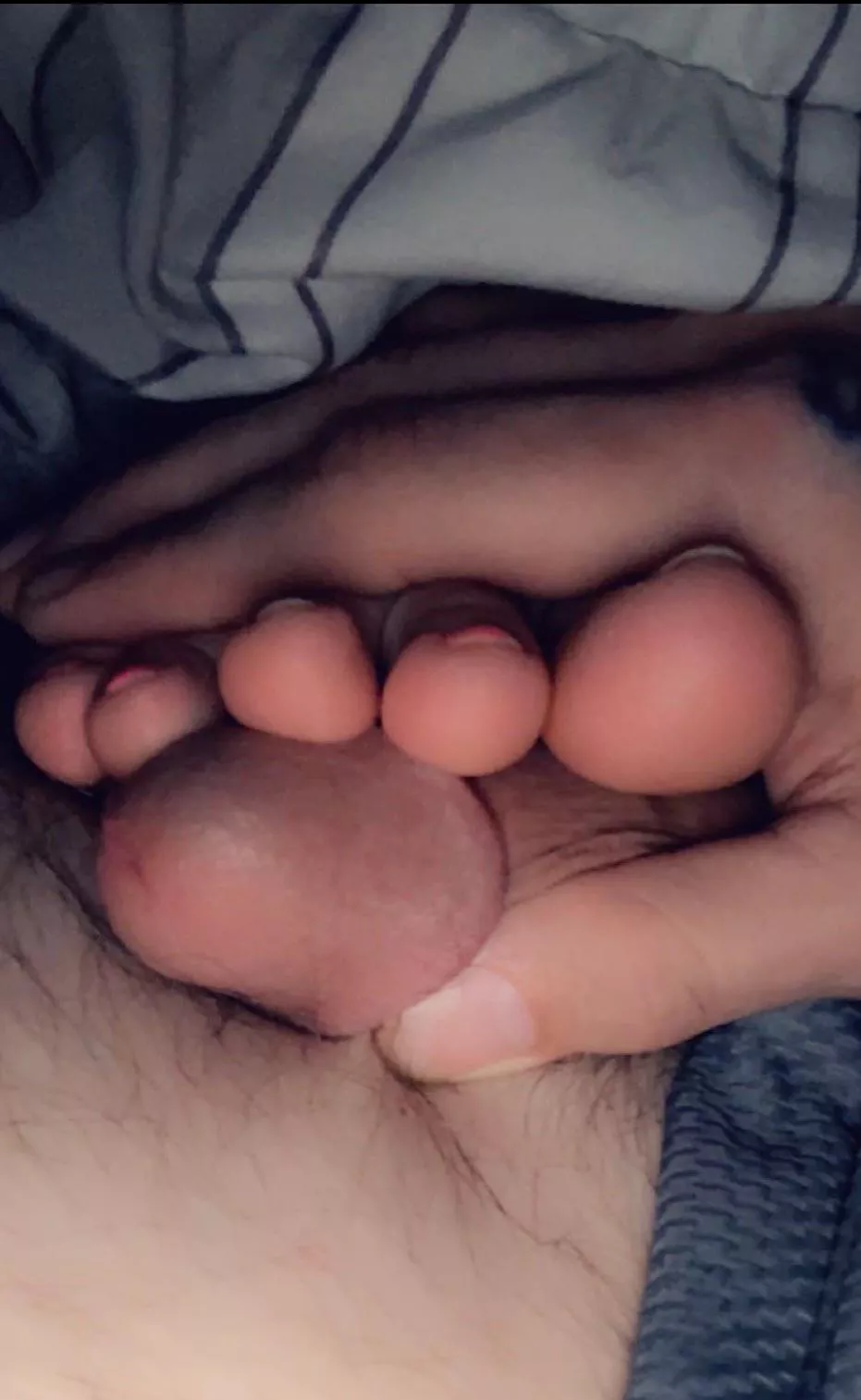 Soft toes pressed against his D