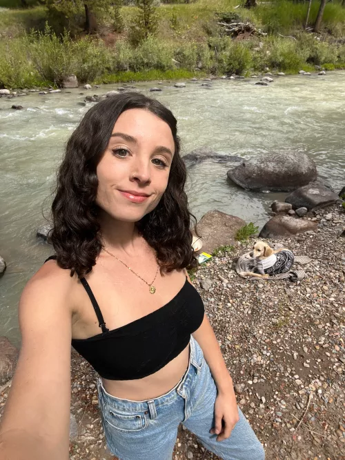 just a girl down by the river with her dog