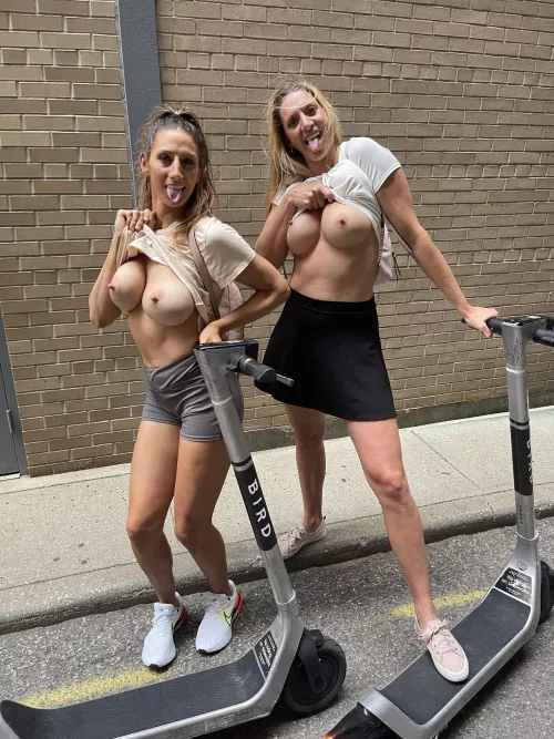 Being naughty girls in the alleyway of downtown.