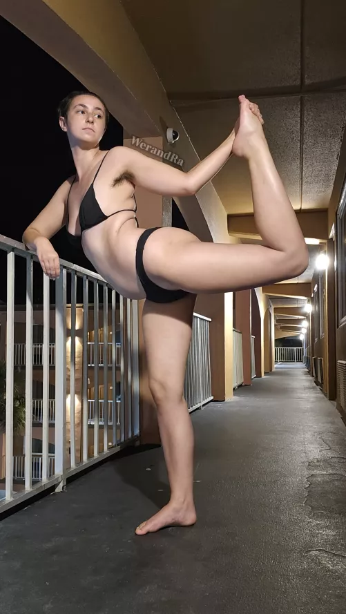 Practicing stretching at the beach resort at night