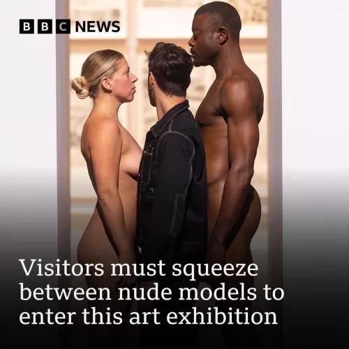 Squeezing through two nude models to enter this art exhibition