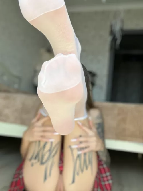 Dive into a world of seduction with my tattooed legs and stockings