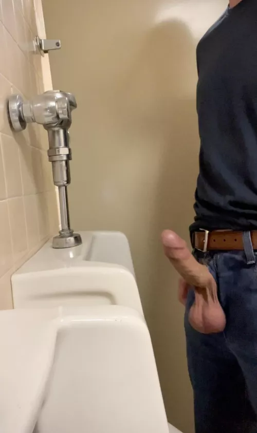 Pulling my cock and balls out at the urinal.