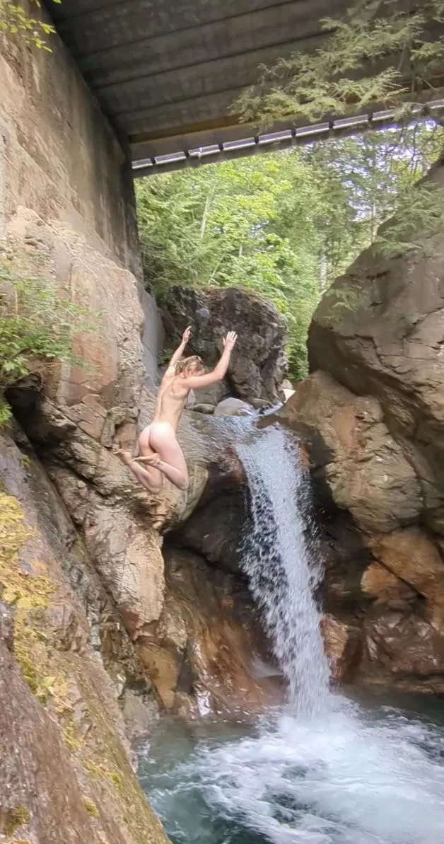 The only way to jump into a waterfall is naked