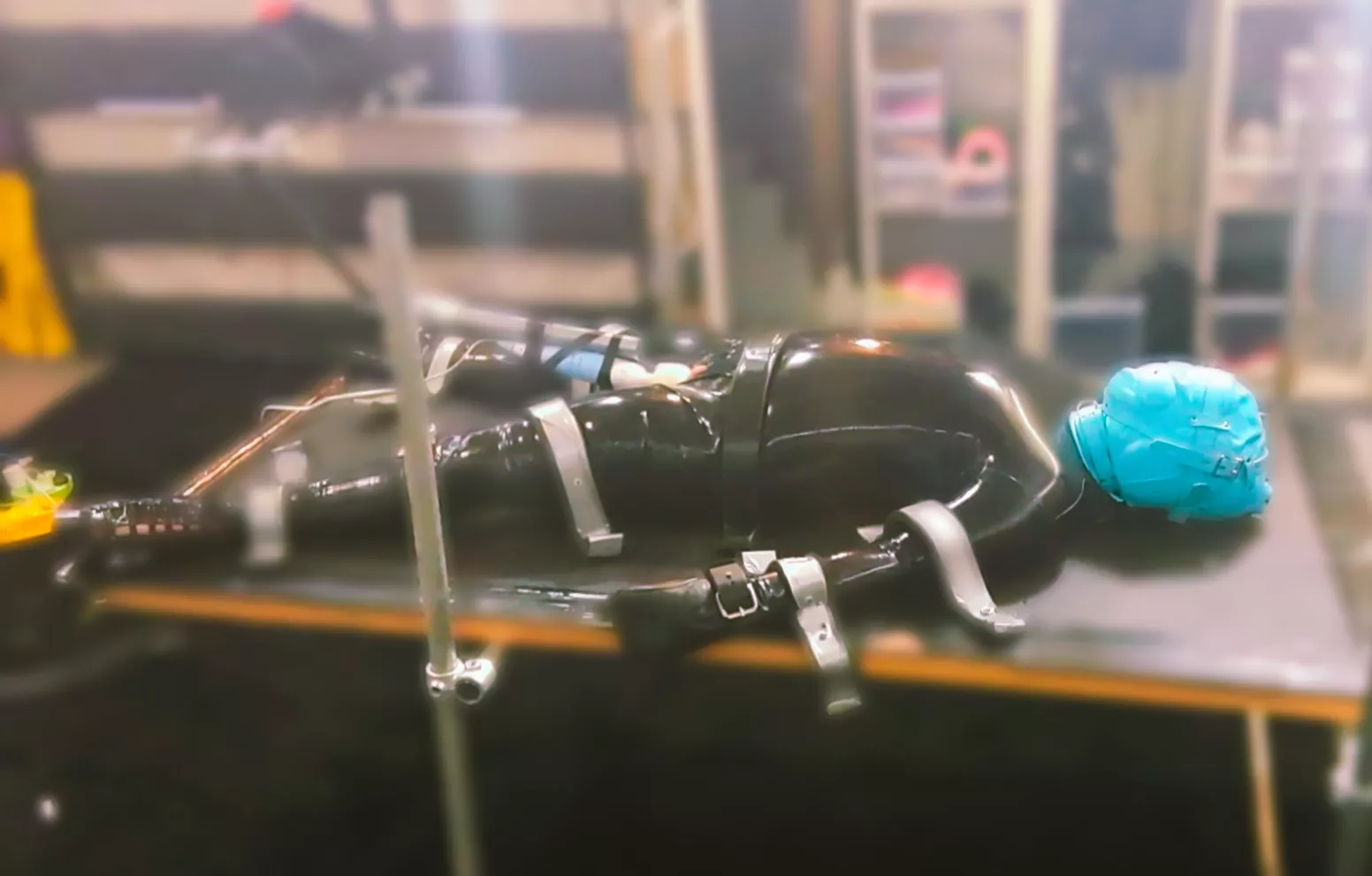 A shiny doll, strapped down and ready to play with