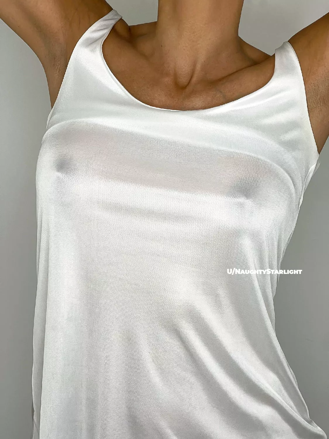 Back to basics: braless in a white tank top