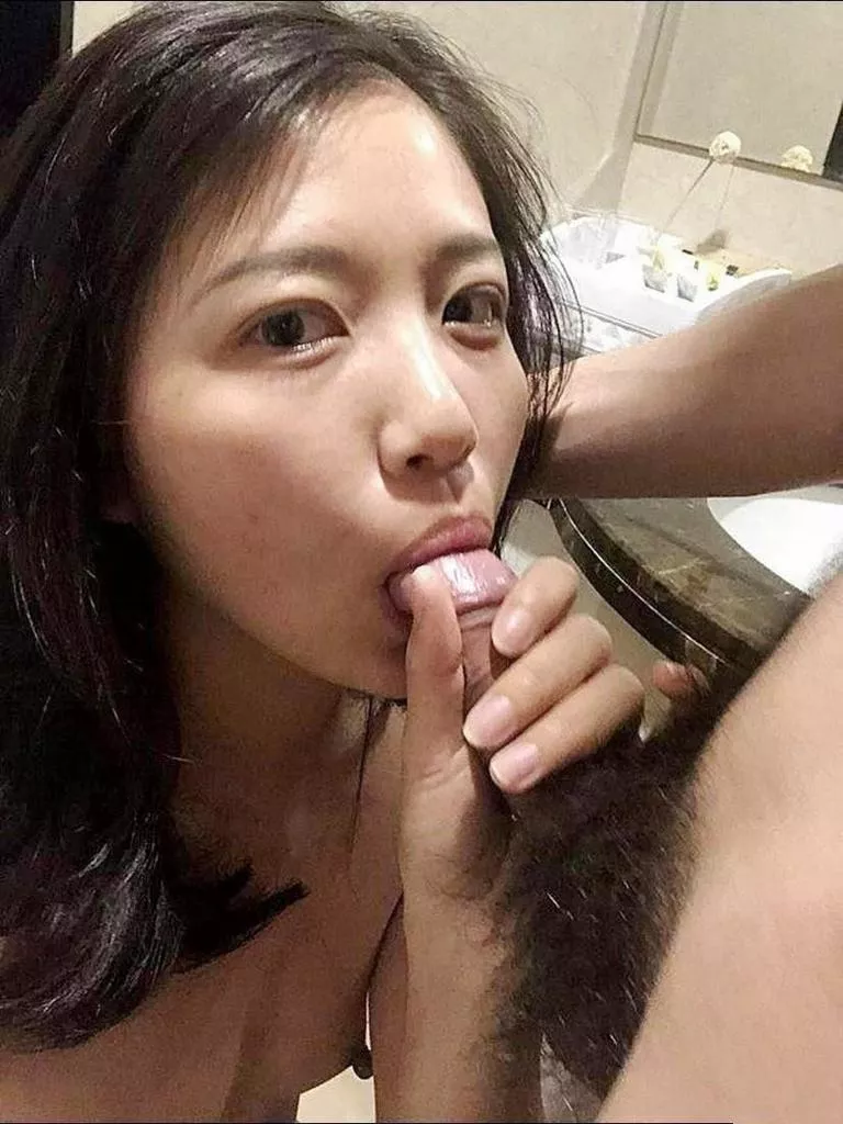 Mature Asian taking a dick in her mouth
