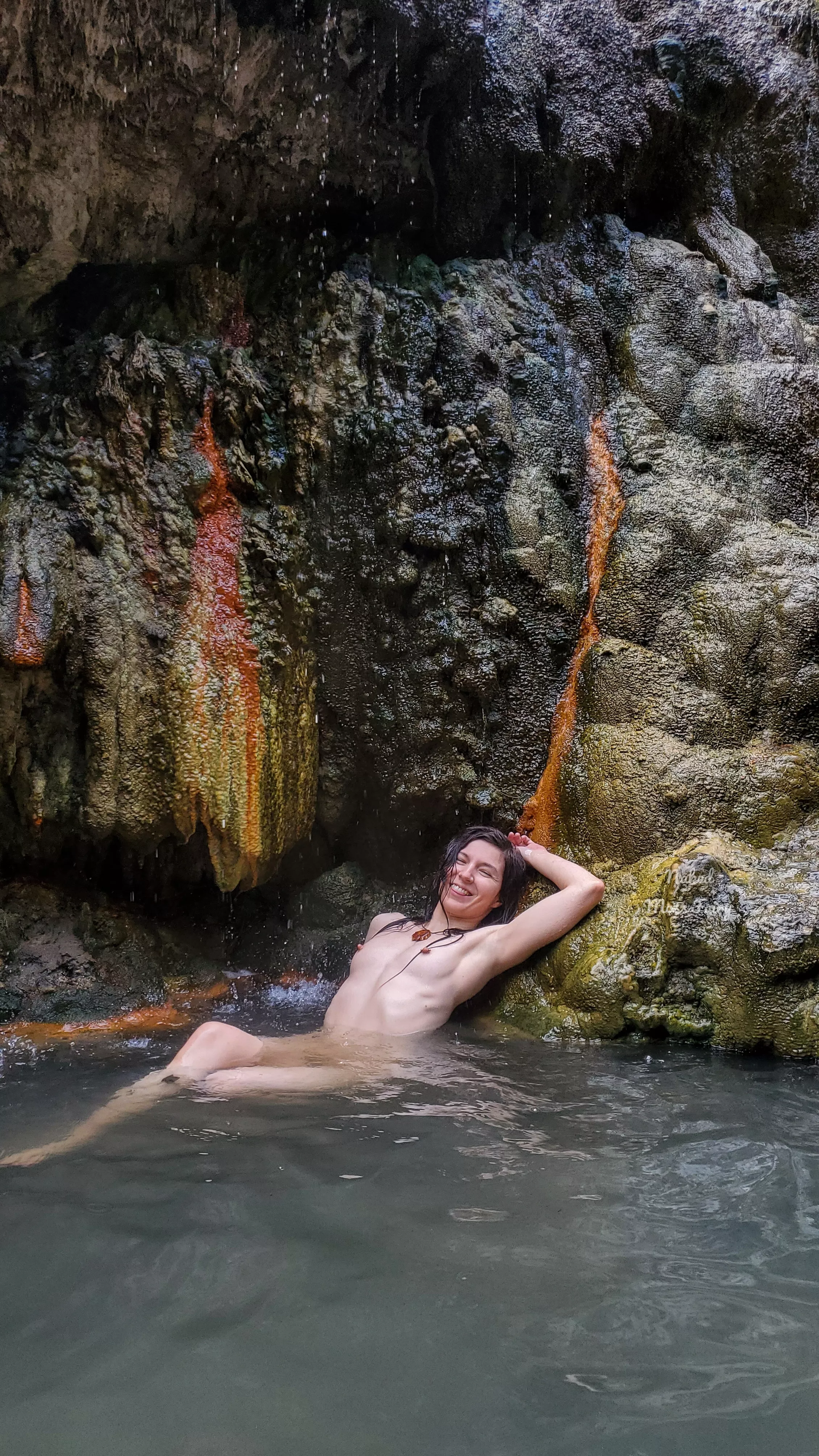 Multi colored minerals dispersed throughout the cave walls of this hot spring😍