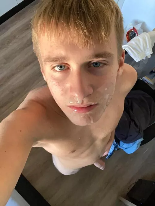 blonde twink covered in cum