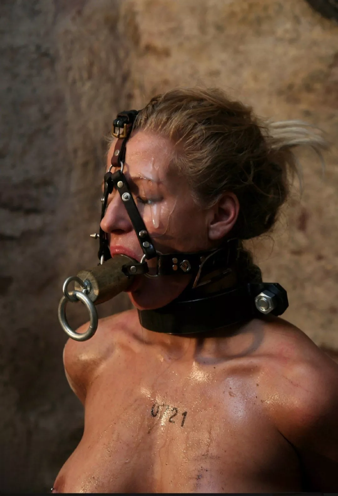 Harness gagged whore covered in cum