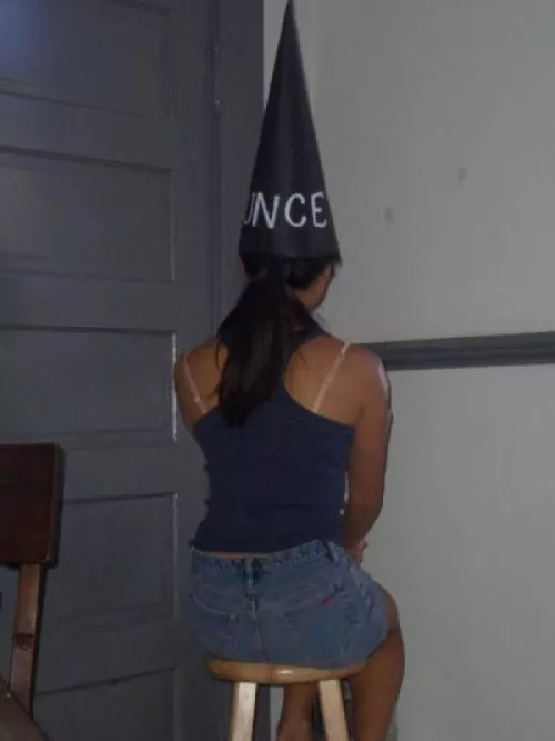 After answering wrong, the cunt waits in the corner for her punishment