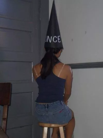 After answering wrong, the cunt waits in the corner for her punishment