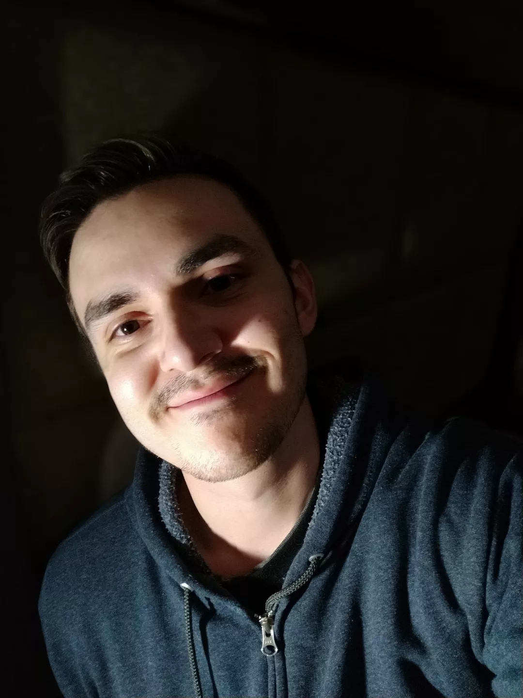 In the dark of this place there's the glow of your face