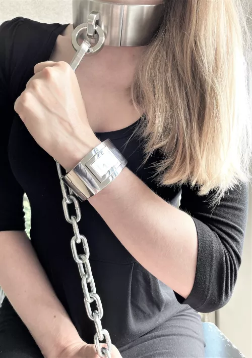 Wearing a steel collar - chained to the wall