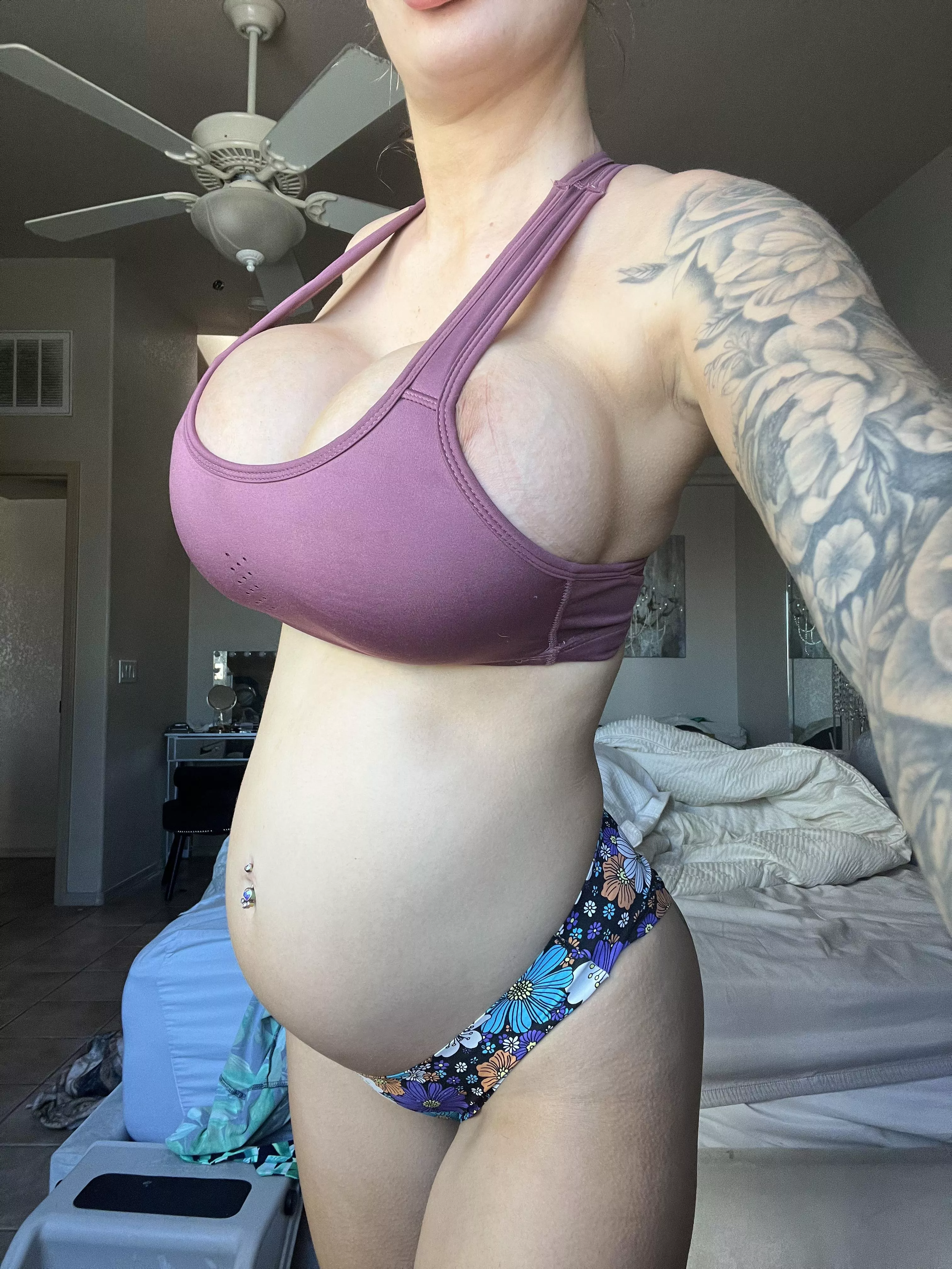 These huge fake tits look good on this growing belly?