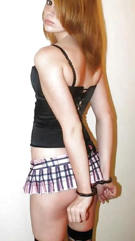 young redhead teen, metal cuffs keeping their hands out of the way