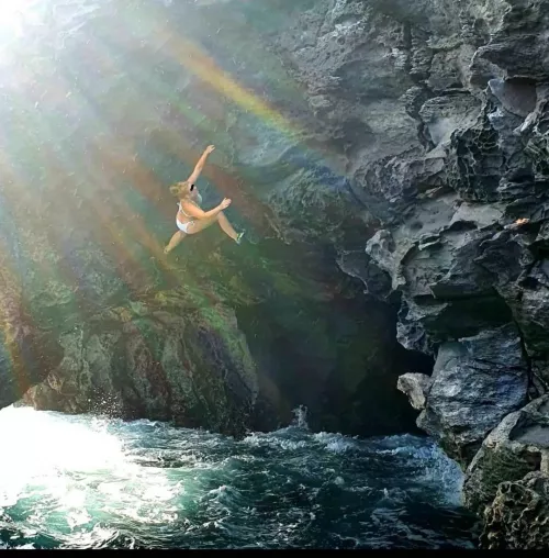 Deep water soloing above a raging sea