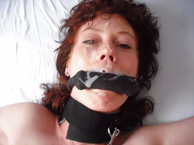 Collared, gagged, and covered in cum