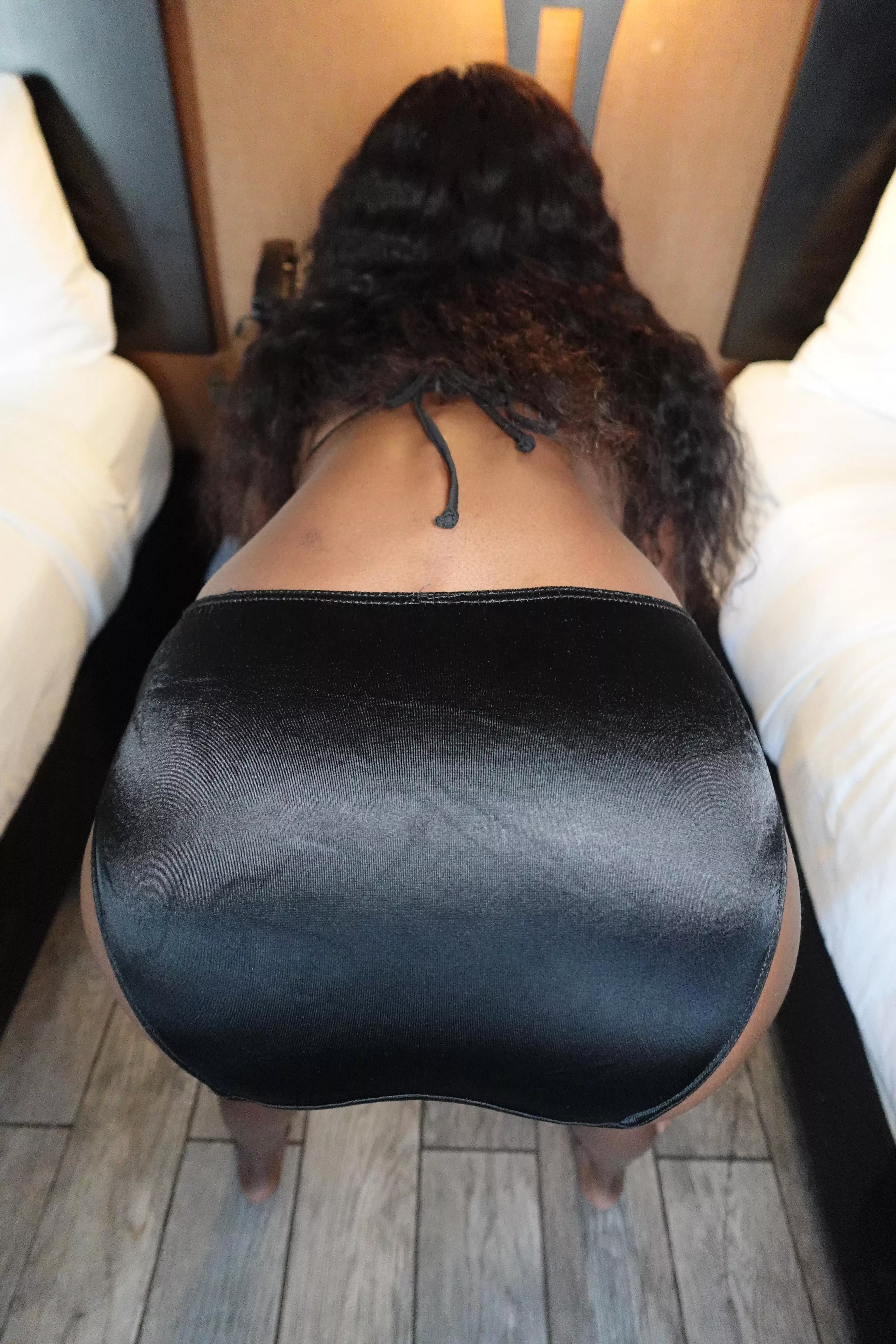 bent over in shiny black satin panties