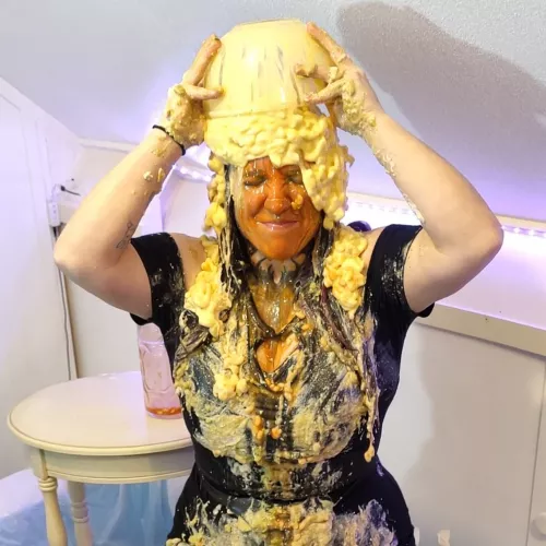 Emptying a bowl of mac and cheese on her head