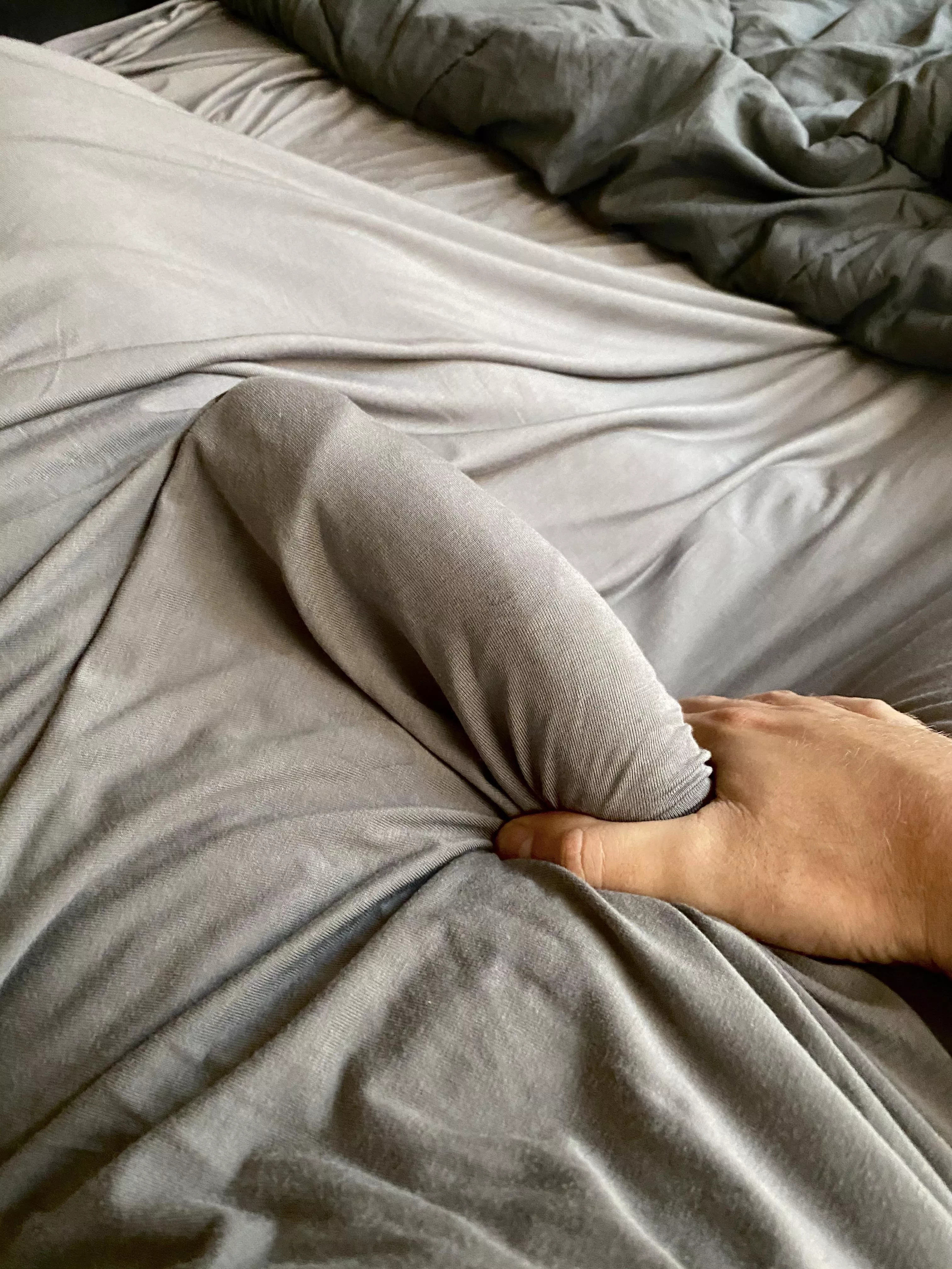 Edging under the sheets next to my sleeping wife