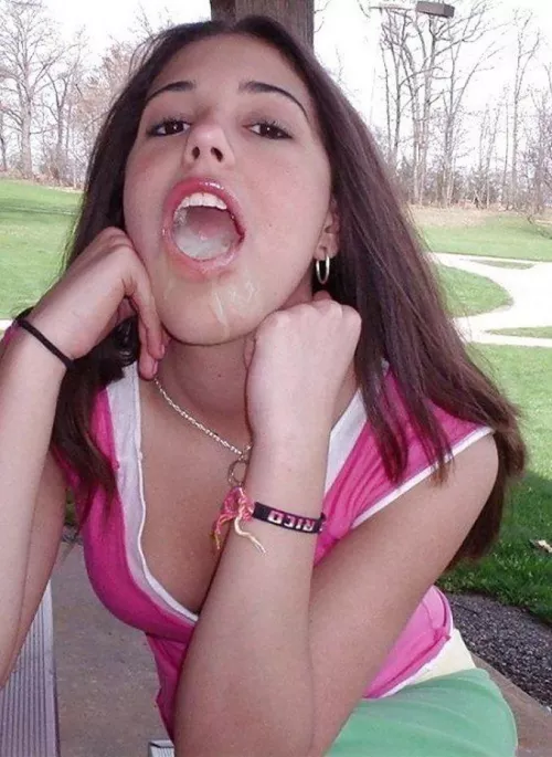 Showing off the load she just took in her mouth