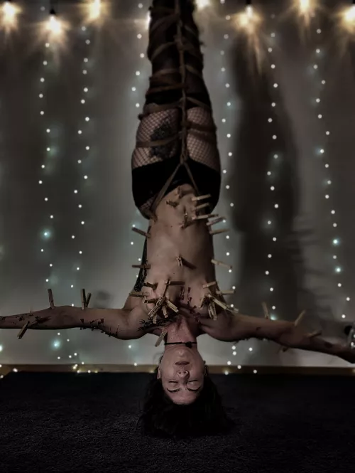 mermaid covered in needles and clothespins