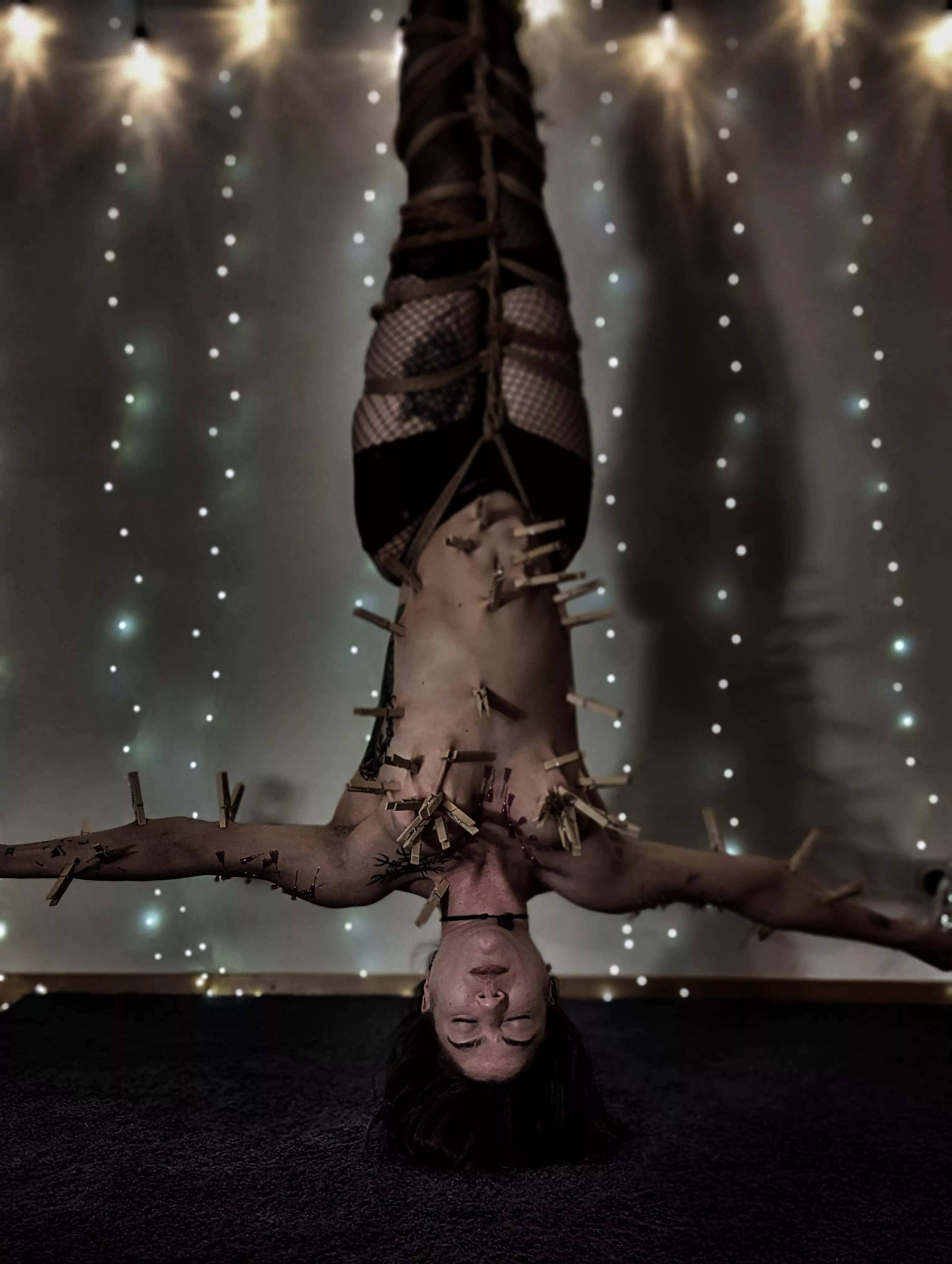 mermaid covered in needles and clothespins