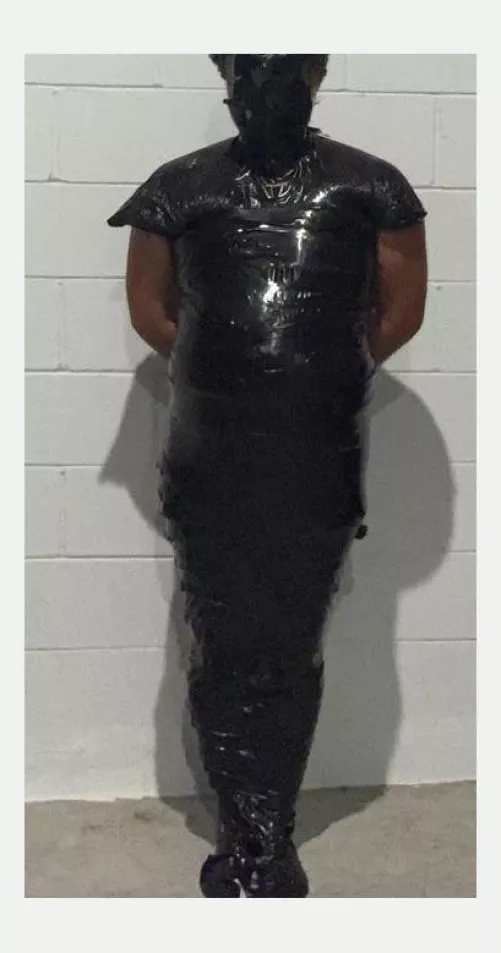 Mummified ln black tape