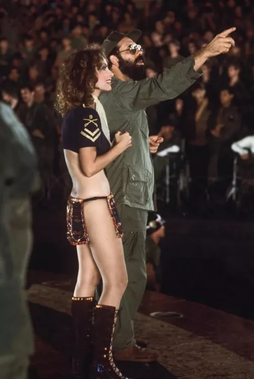 Francis Ford Coppola and playmate Linda Beatty on the set of Apocalypse Now (between 1975-79)