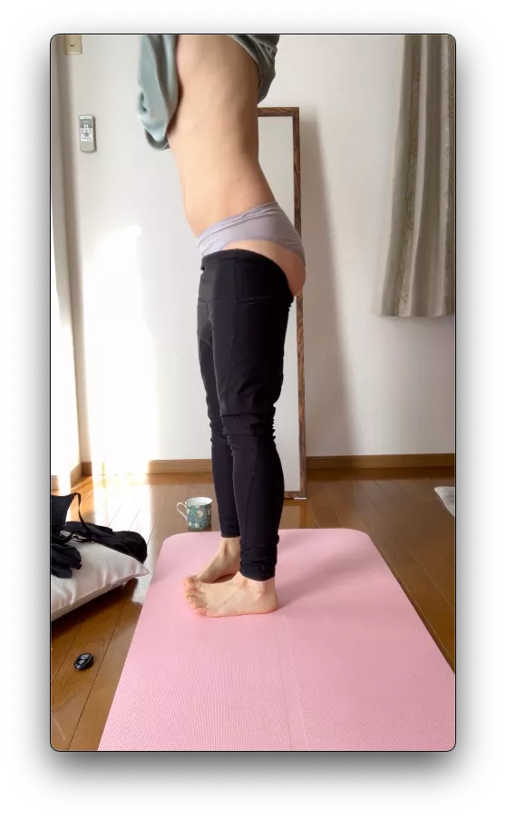 on yoga mat by window