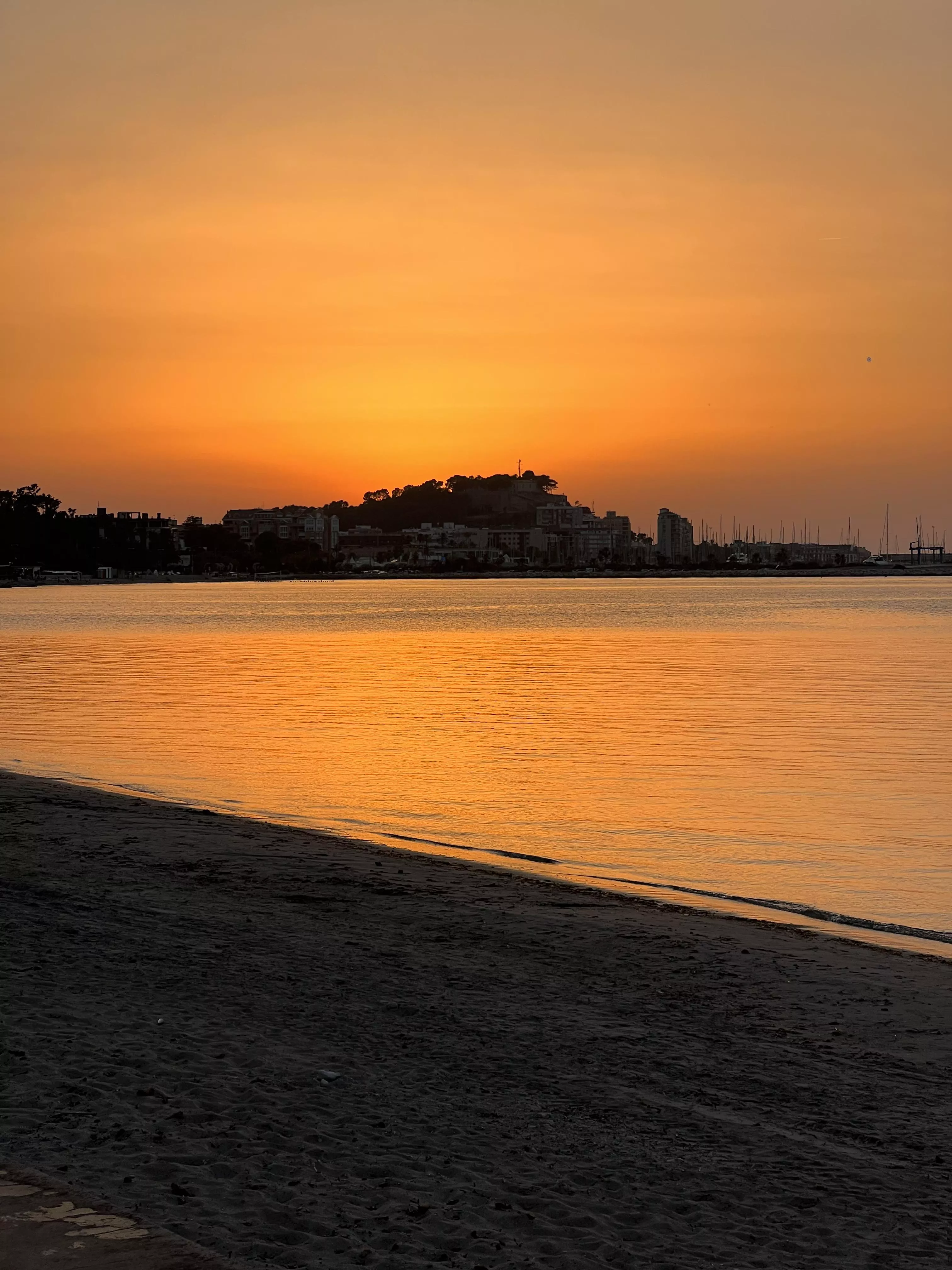 Beach with sunset view of the village castle