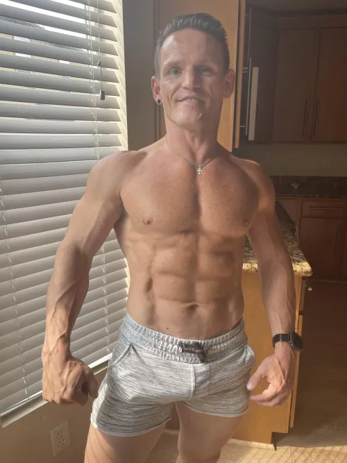 Muscles flexed and veins popping after workout.