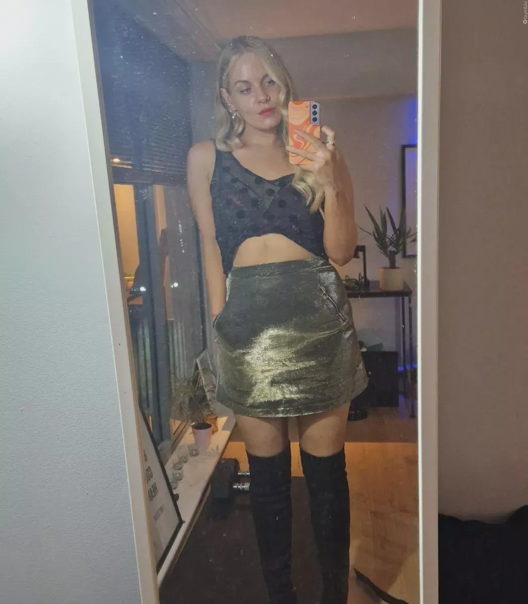 Sheer black polka dot top with a purple bra