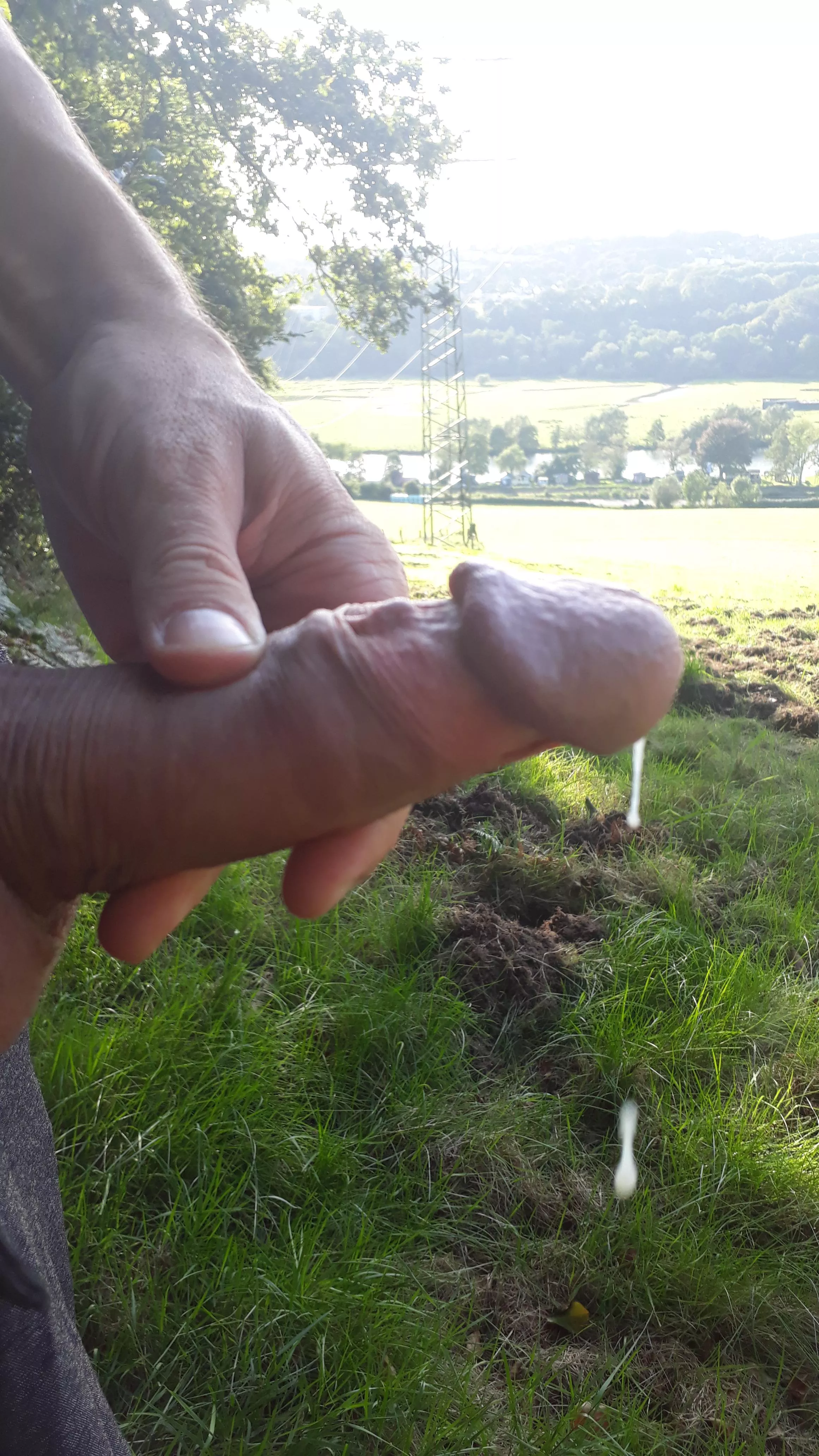 Cumming in nature with a view