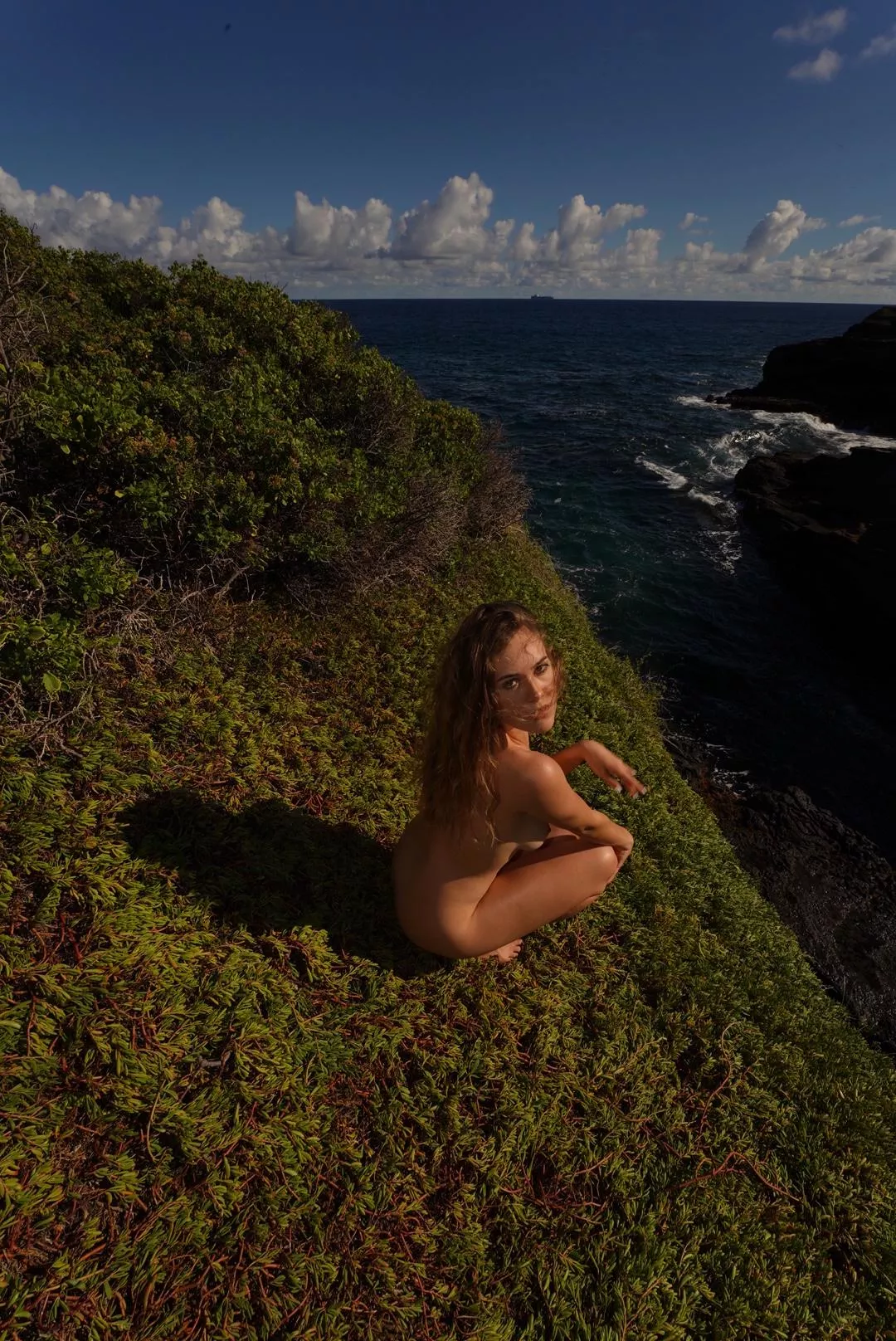 Naked on the edge of a cliff