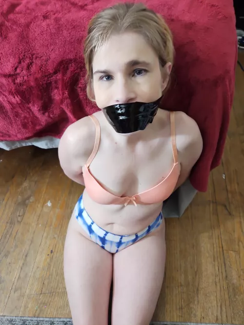 Bondage tape gagged. 